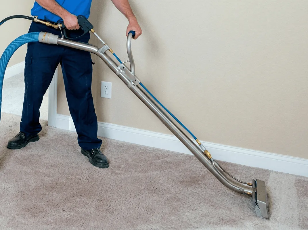Professional operating a liquid removal machine on a carpeted floor in Springfield, MO